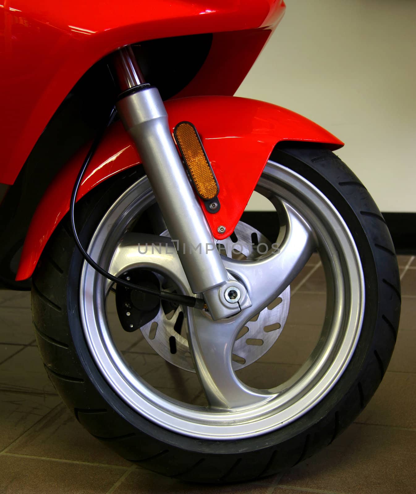 Front wheel of a red scooter
