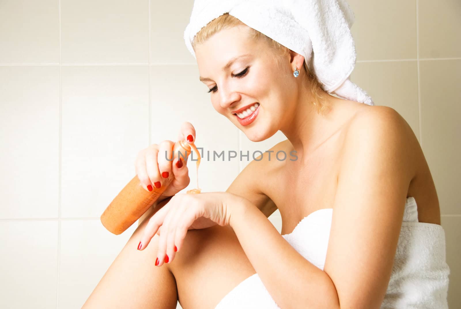 beautiful happy woman pampering herself in the bathroom after the shower