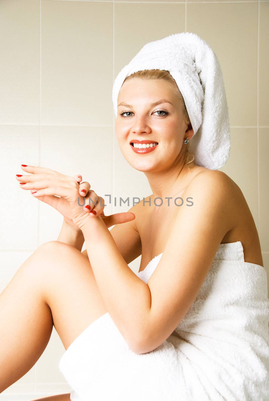 beautiful happy woman pampering herself in the bathroom after the shower
