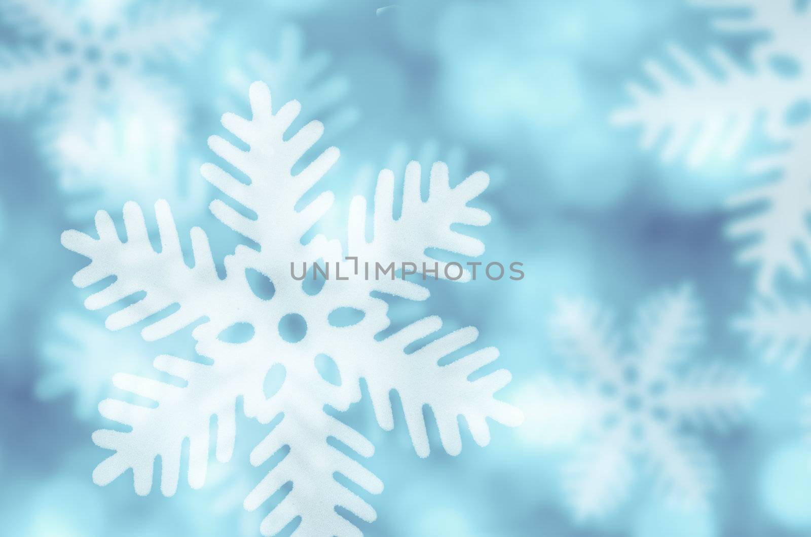 Winter blue background with snowflakes falling.