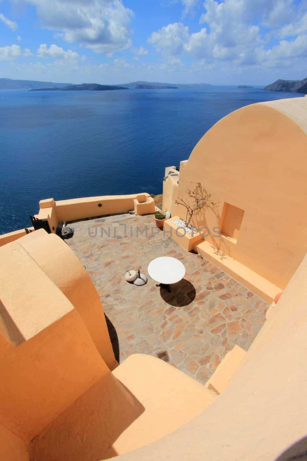 View on the mediterranean sea from the balcony of an orange house at Oia, Santorini, Greece, by beautiful weather