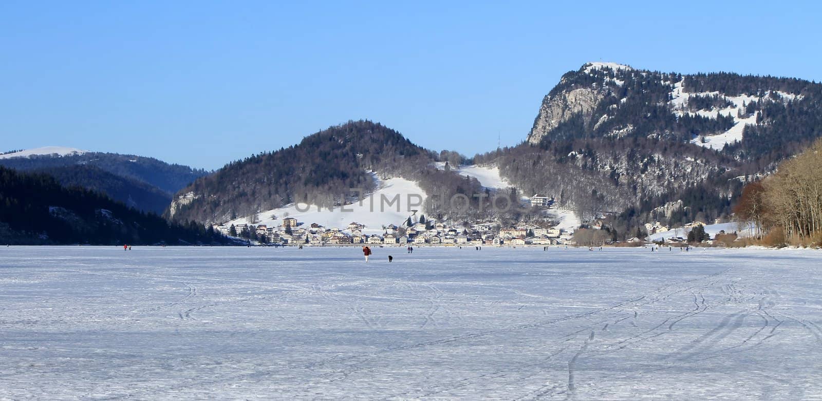Frozen lake of the Joux valley and Le Pont village, Switzerland by Elenaphotos21