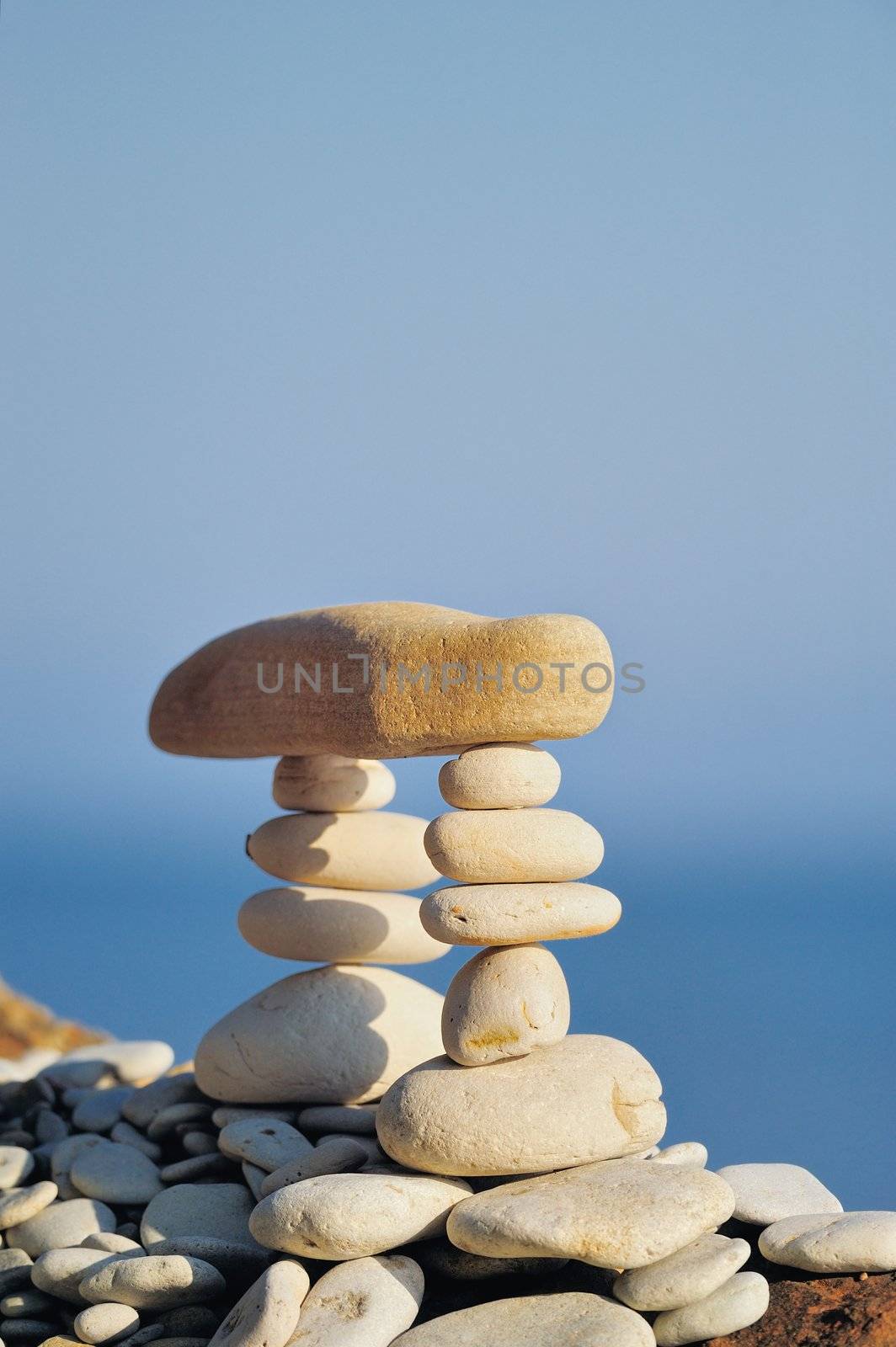 Long horizontal stone between a piles of pebble