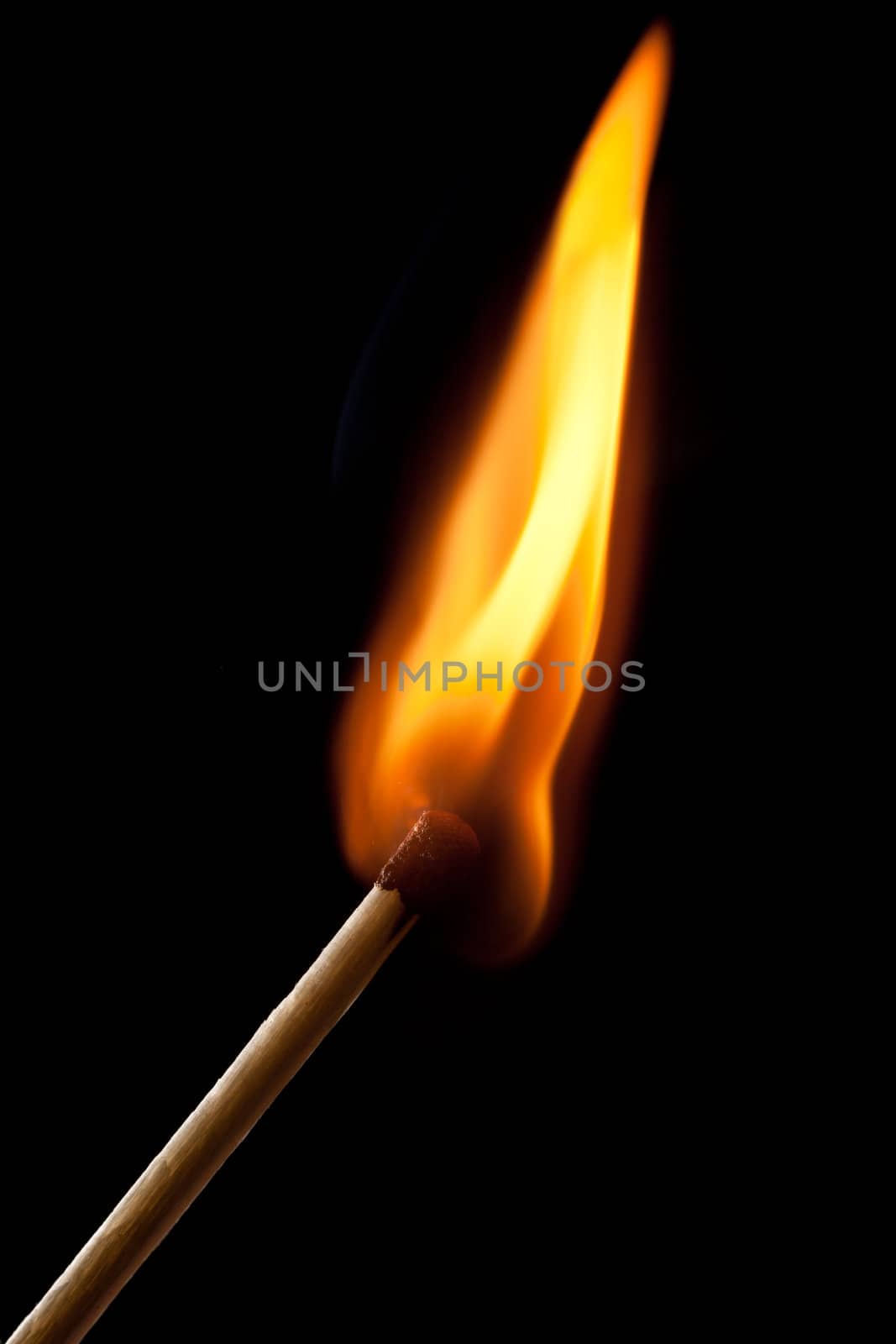 Burning match on a black background 