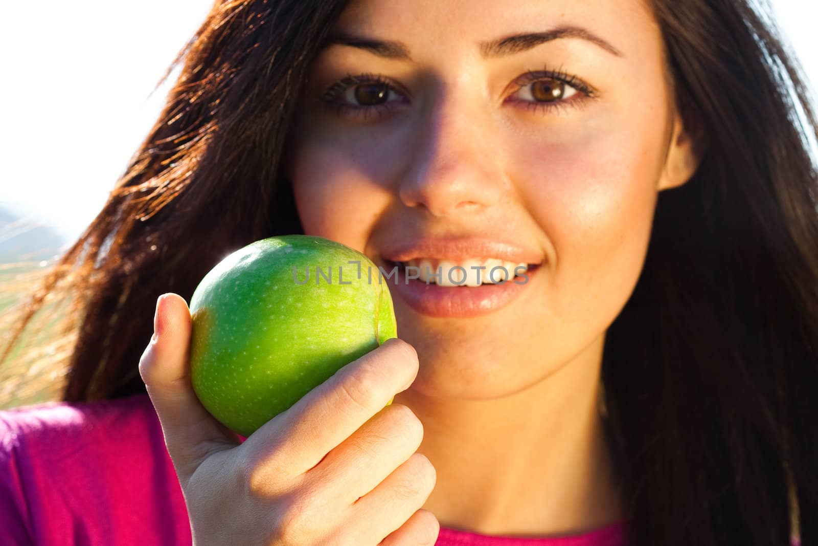 portrait of a beautiful young woman with apple  outdoor