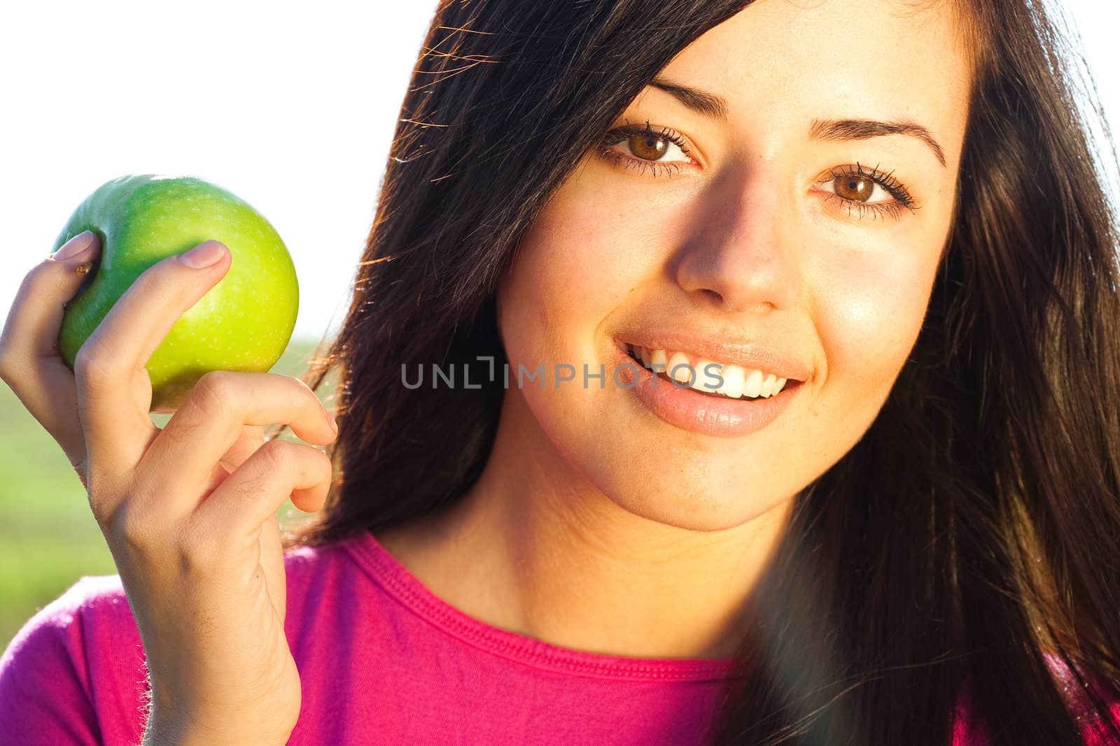 portrait of a beautiful young woman with apple  outdoor