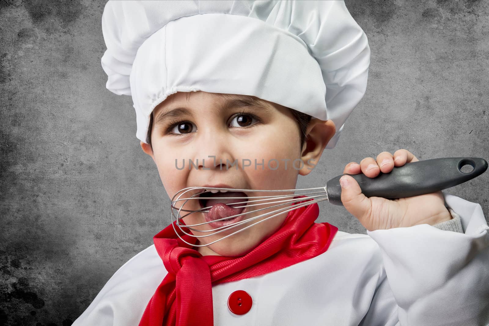 A little boy cook in uniform over vintage background