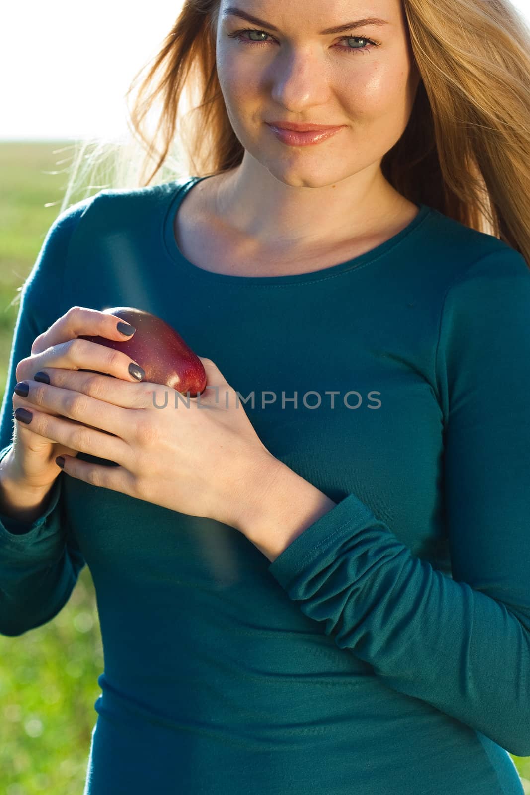 portrait of a beautiful young woman with apple  outdoor