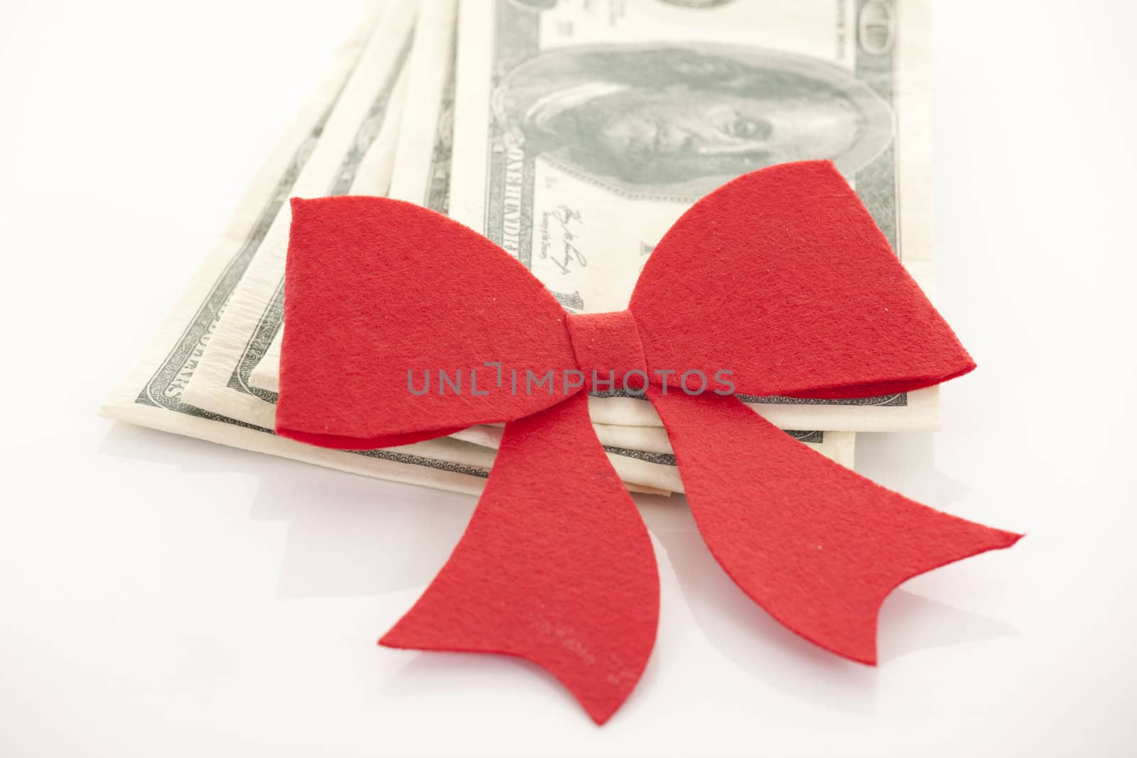 Money, gift wrapped in red bow and ribbon, one hundred dollars b by senkaya