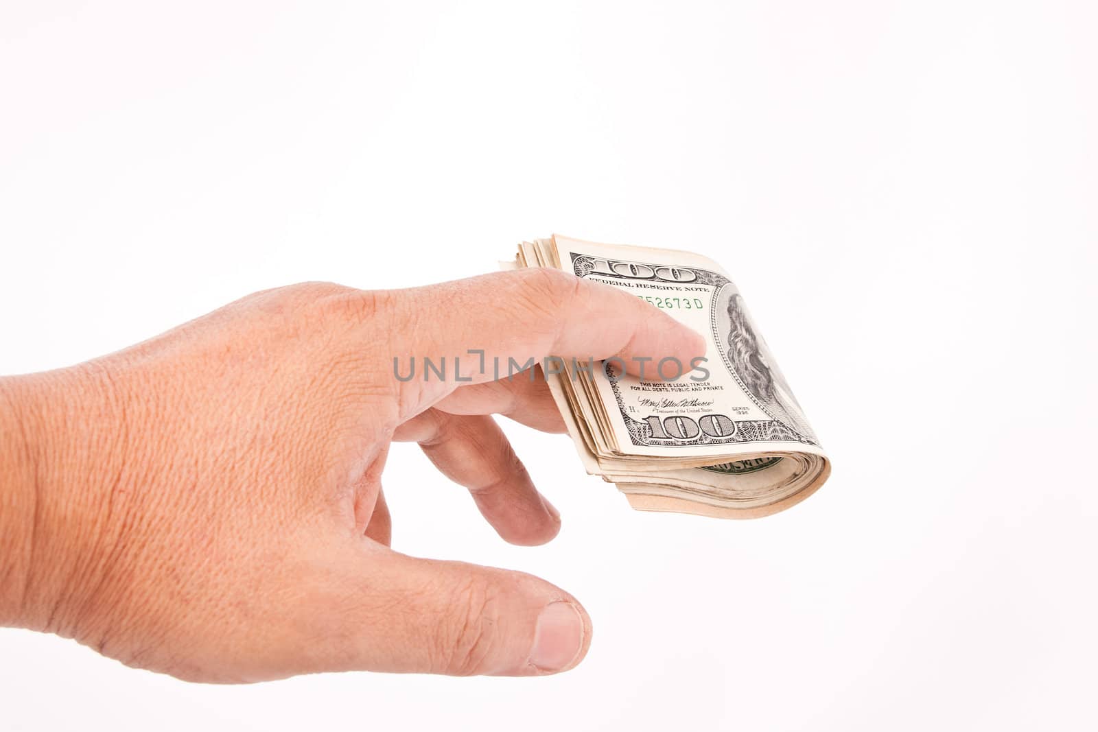 Man's hand giving dollars. Isolated on white.