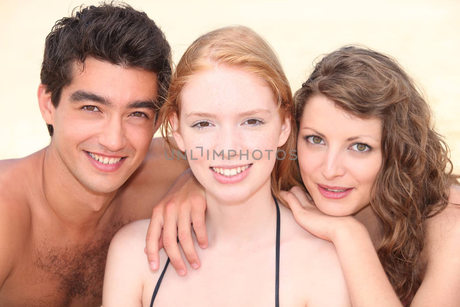 Three teenagers on the beach by phovoir