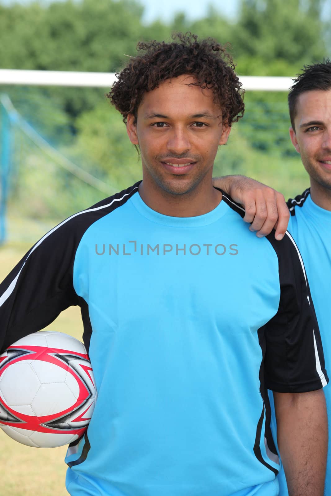 Footballer standing in front of goal by phovoir