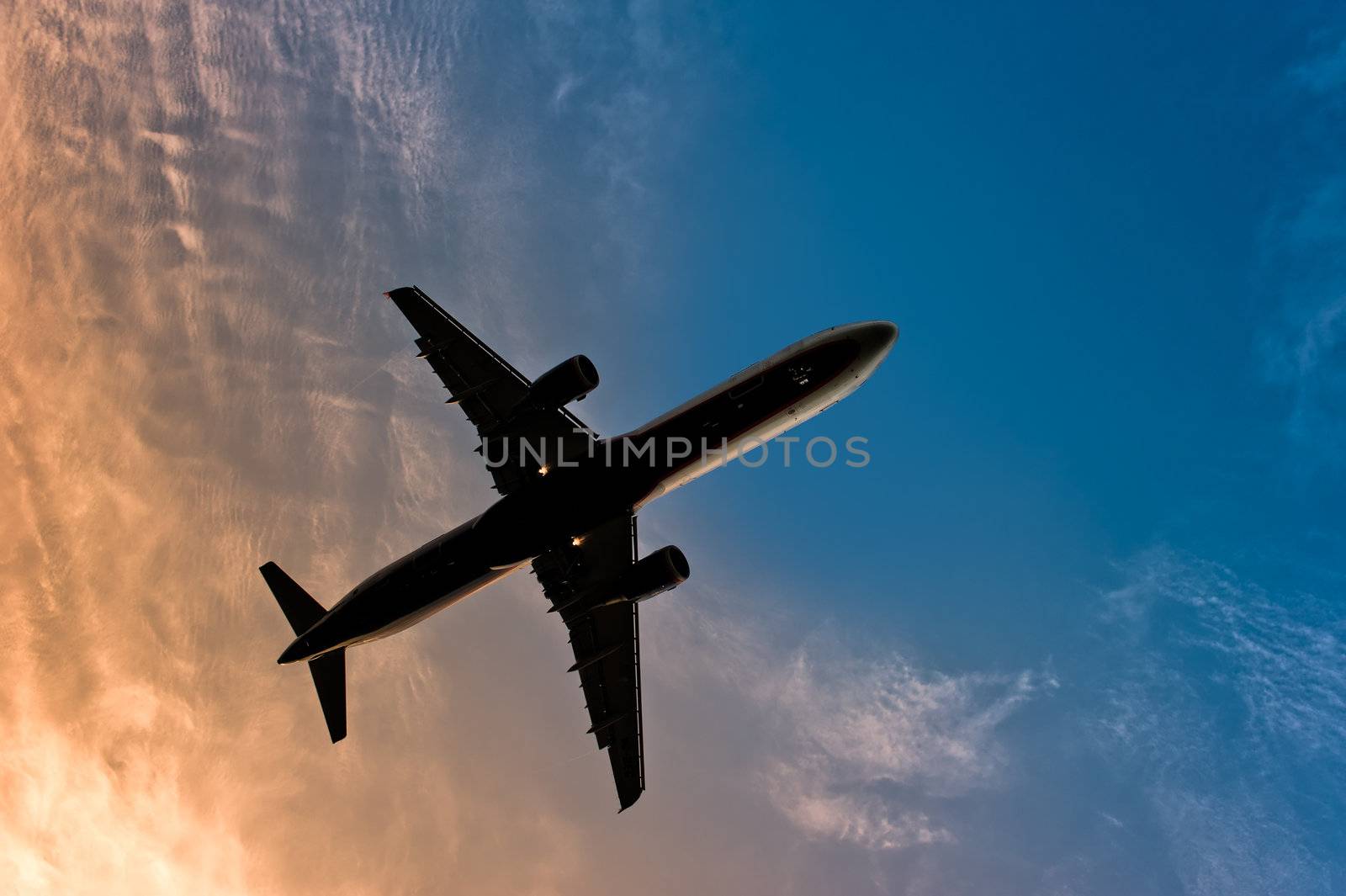 Airliner silhouette against the blue sky by kosmsos111