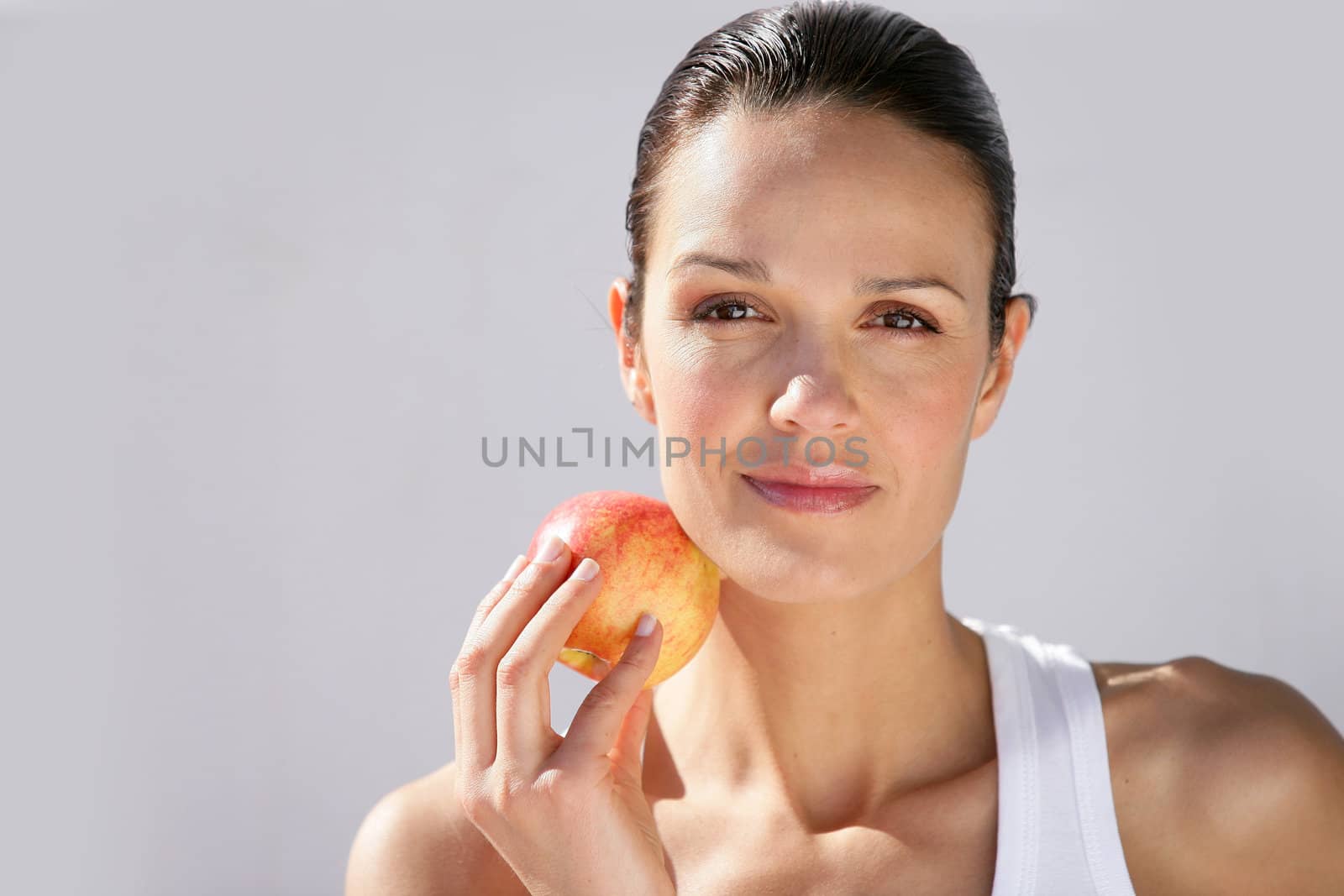 Woman with apple in hand by phovoir