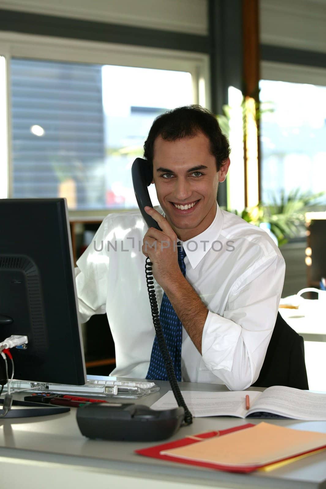 businessman at his desk talking on the phone