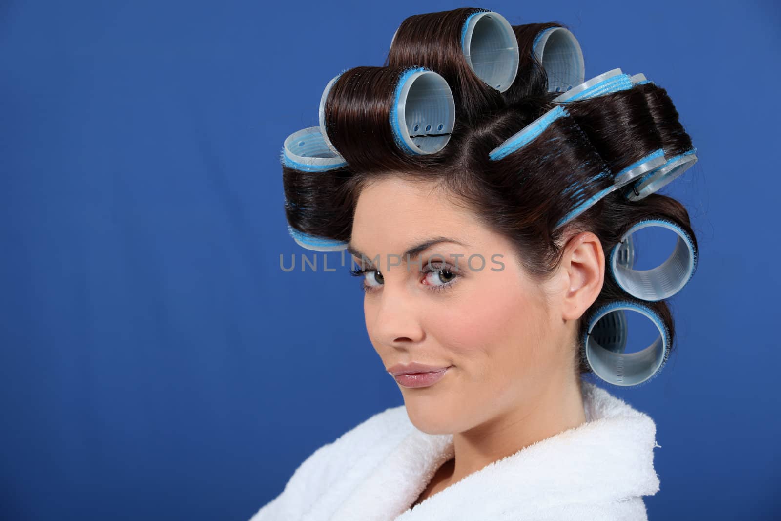woman with hair curlers pouting by phovoir