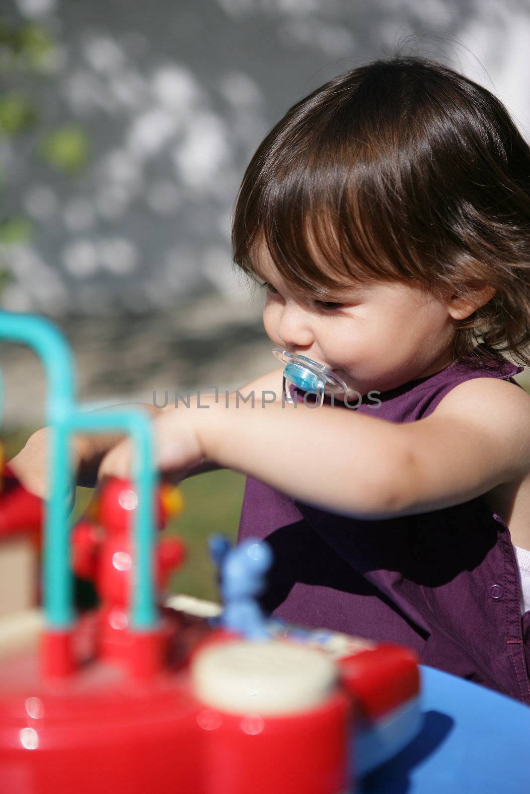 A toddler playing with her toys