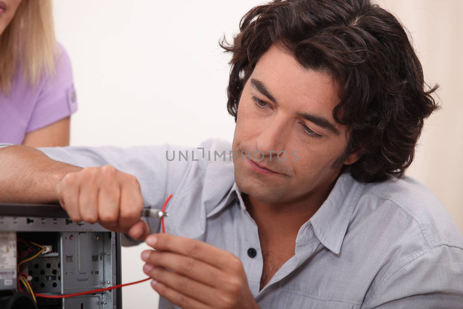 Man fixing a hard drive by phovoir
