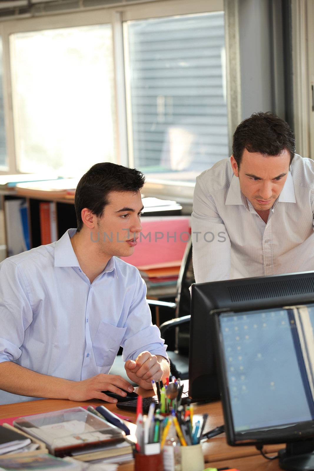 twosome of male employees in office by phovoir