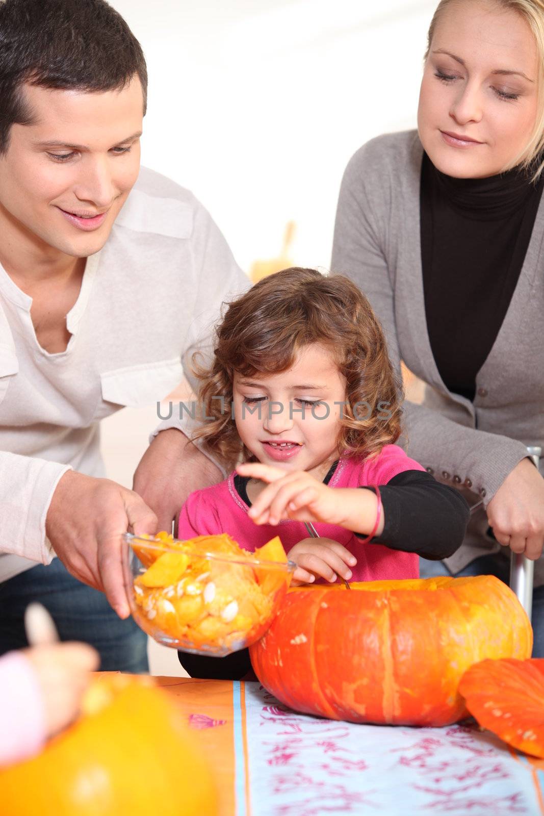 Family carving hallowe'en pumpkin