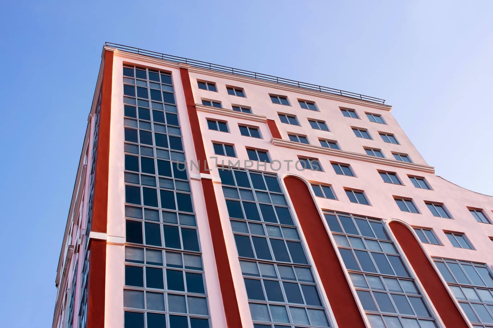 Building new construction in the rays of setting sun against a blue sky