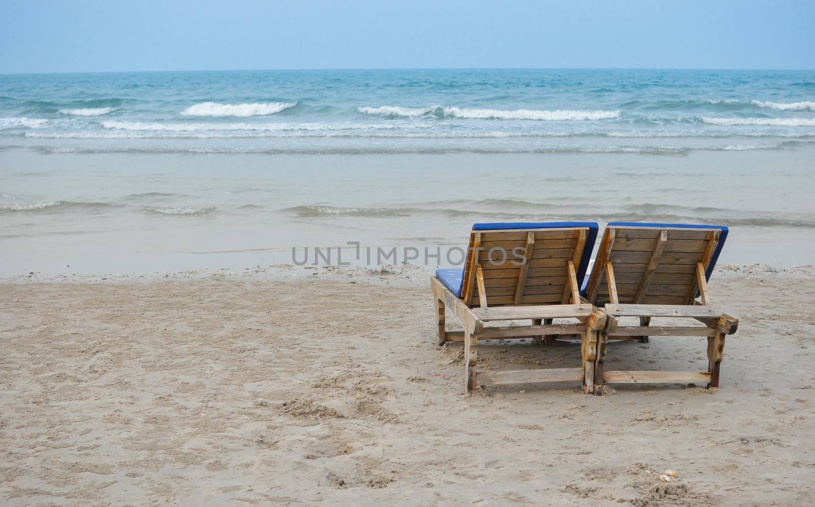 Couple chair on the beach by pachanon