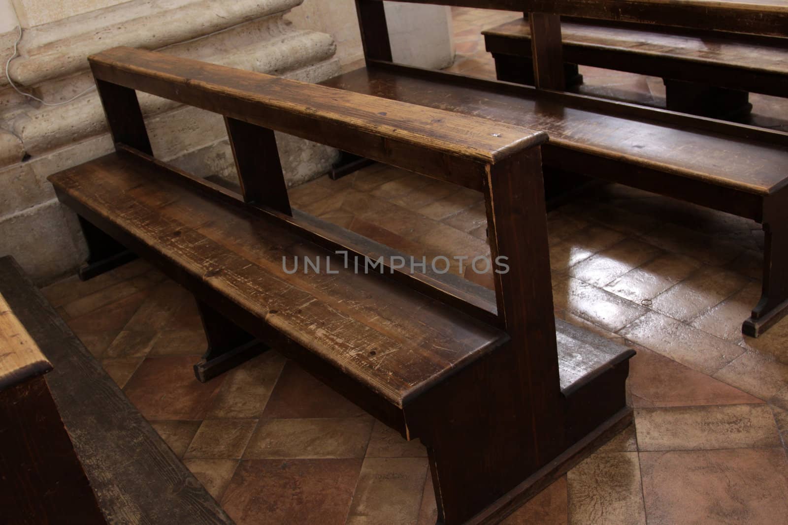 Worn Church pews in a basilica in Italy.