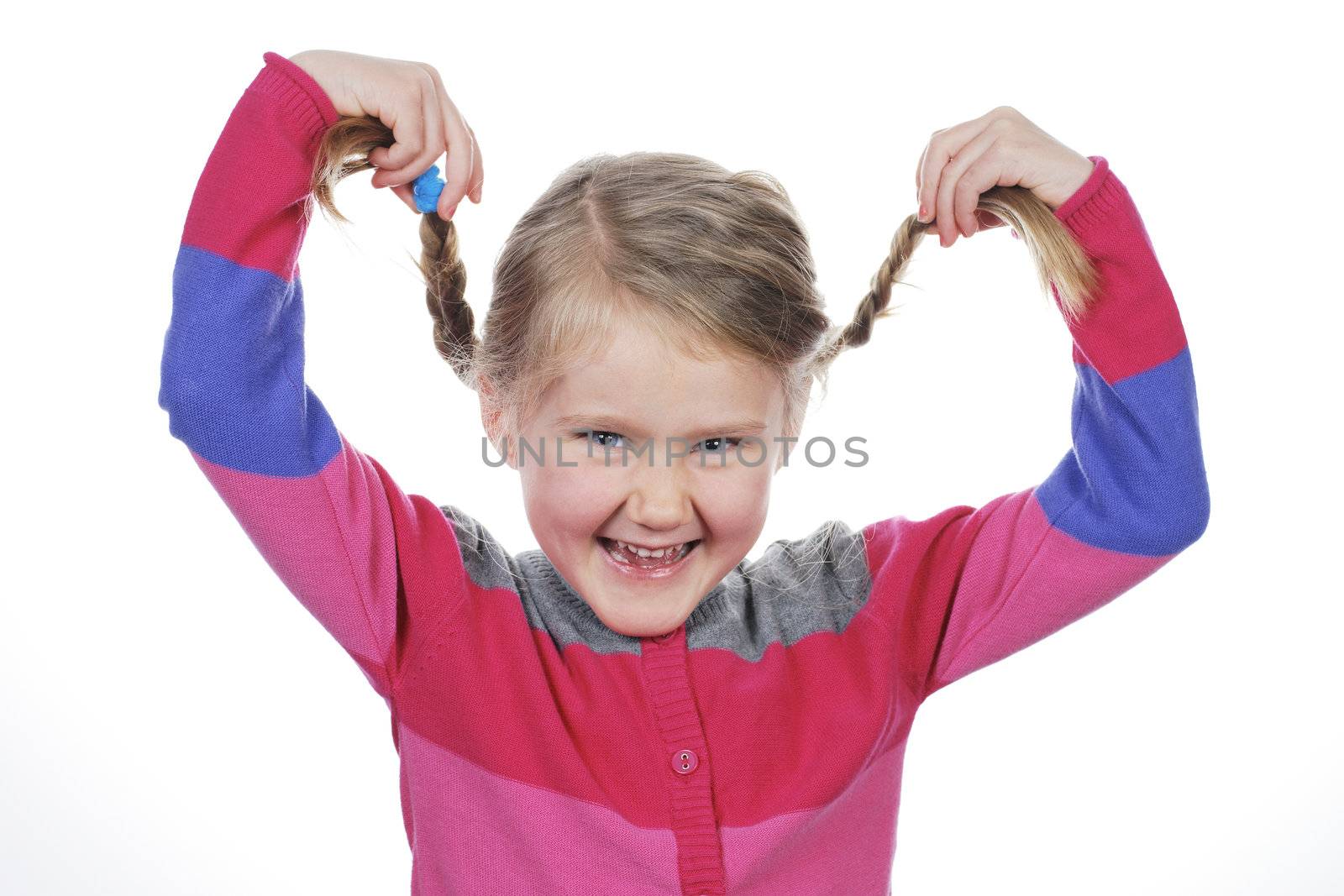 Little girl making funny face on white background