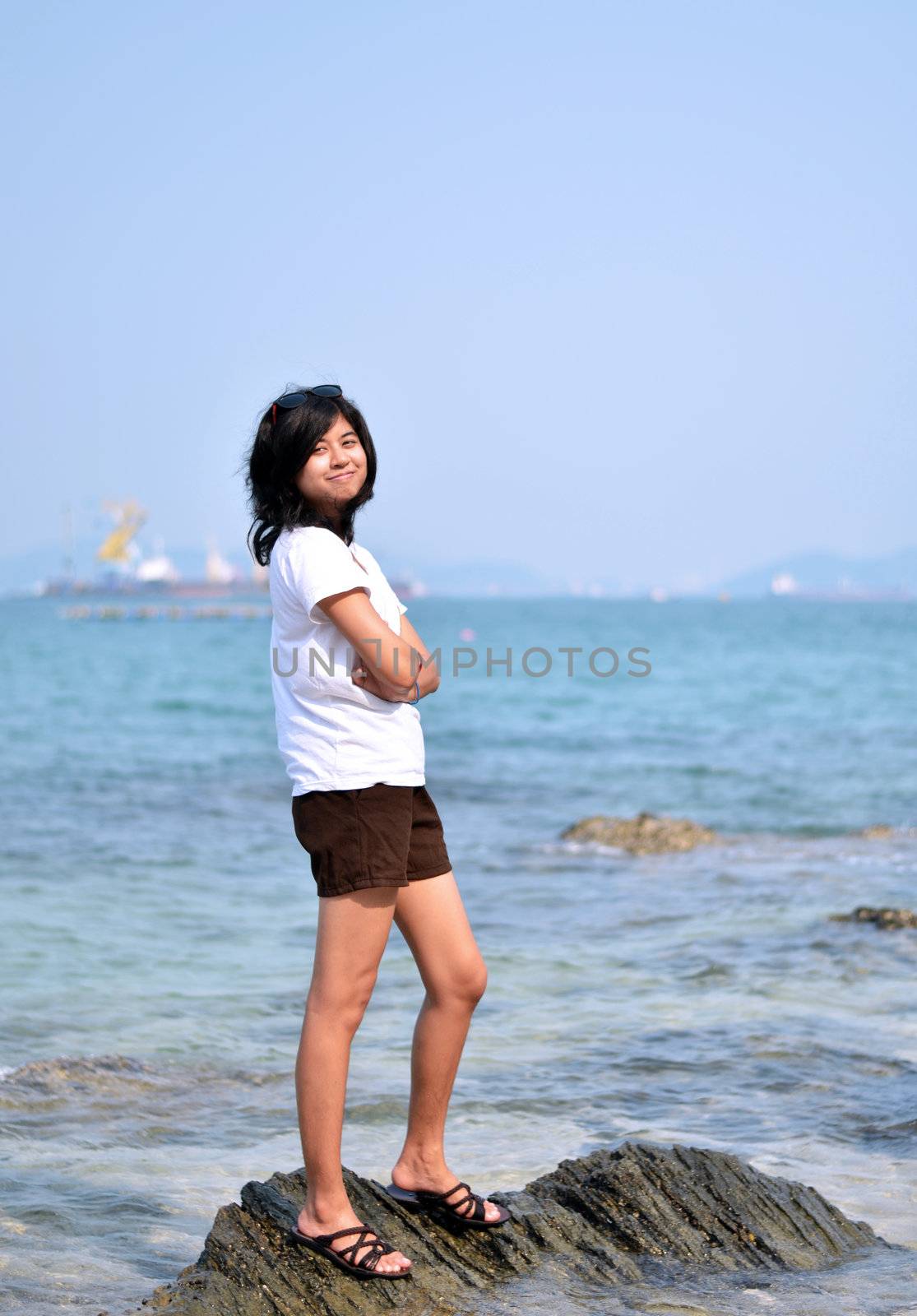 Beautiful young asian woman on beach by siraanamwong