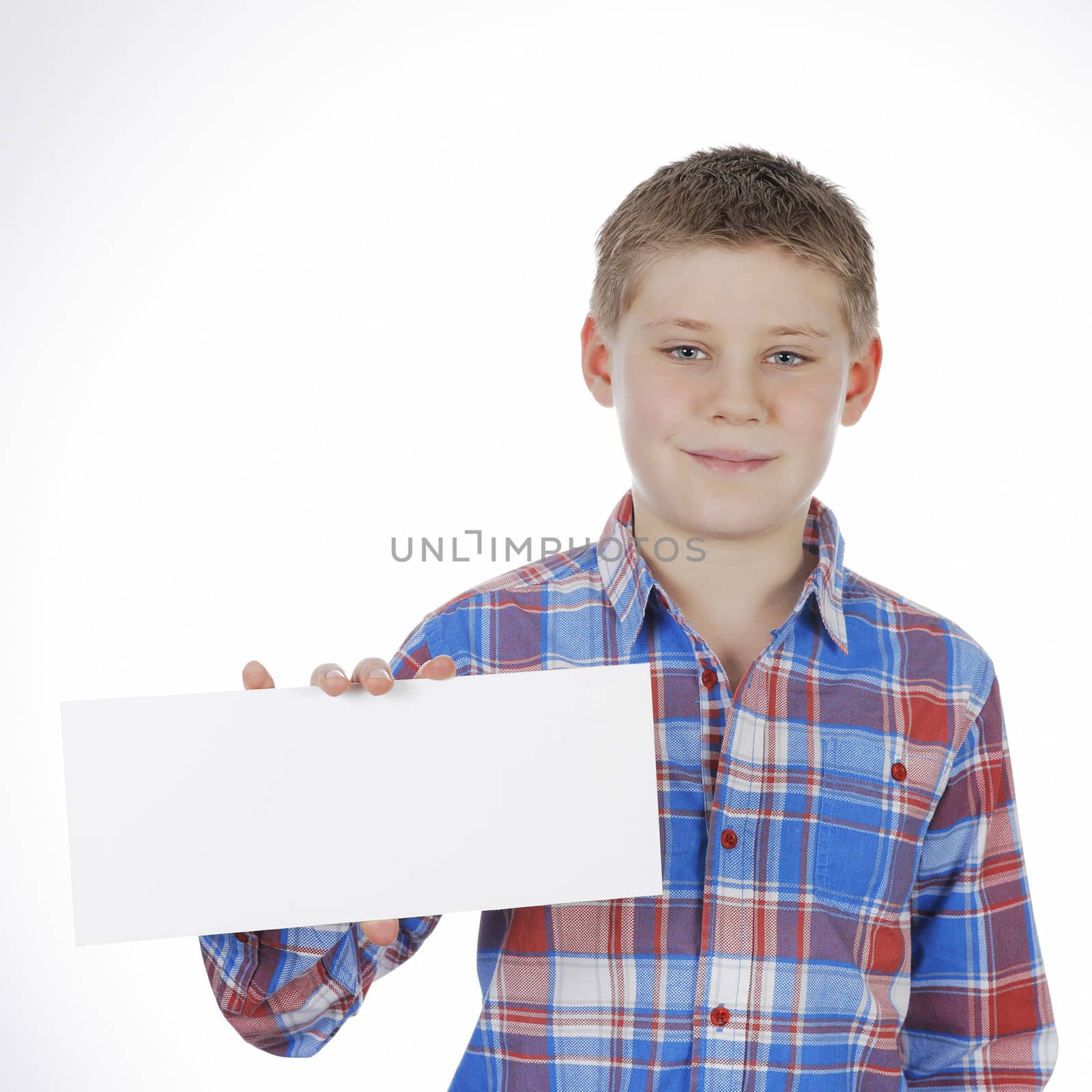 Smiling boy standing with empty horizontal blank in hand