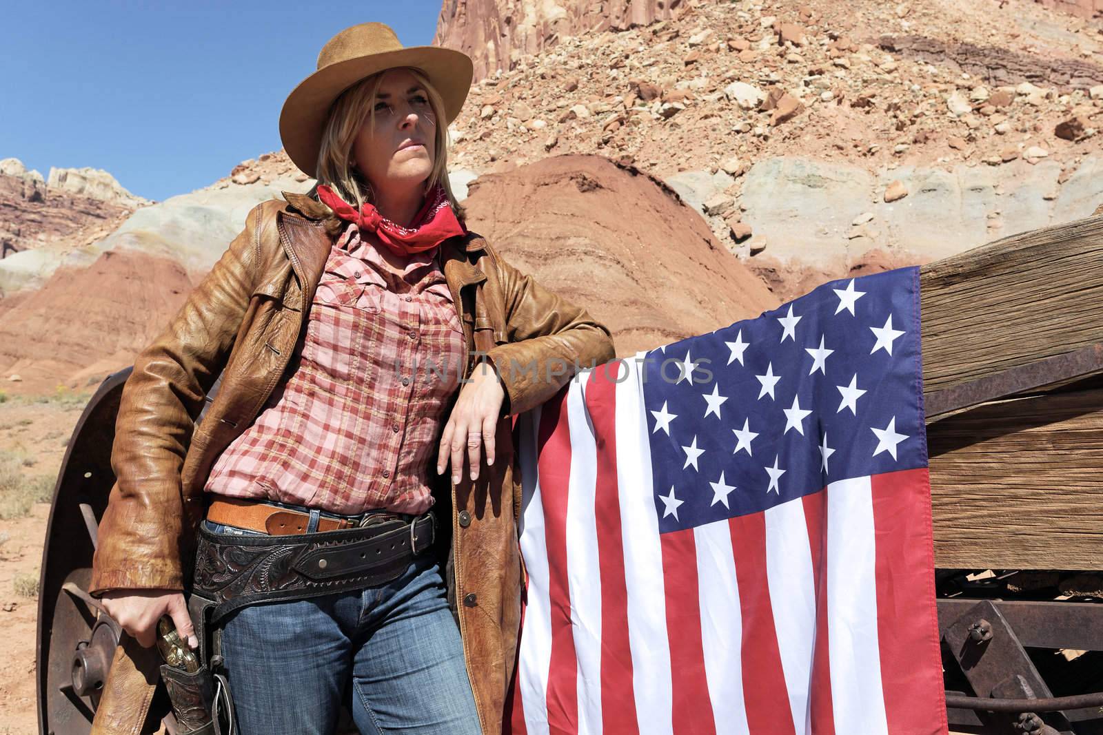 portrait of a young blond cowgirl with american flag