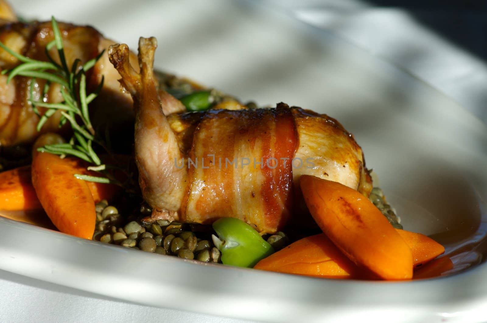 Image of bacon wrapped quail with vegetables