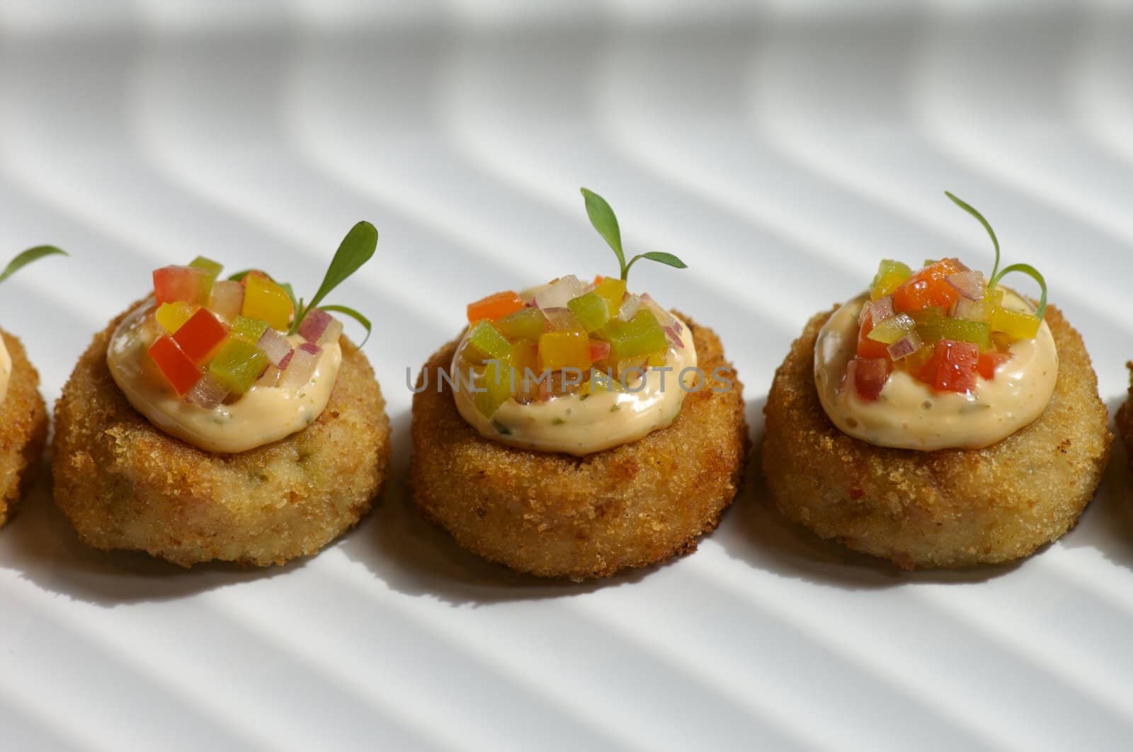 Image of miniture crab cakes with garnish