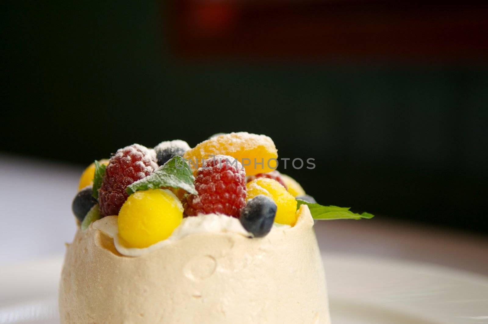 Image of merangue topped with mixed fruit