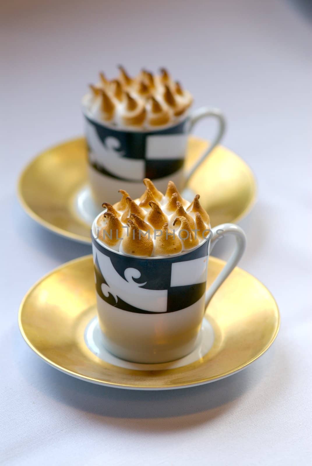 Image of mugs of cappaccino on saucers