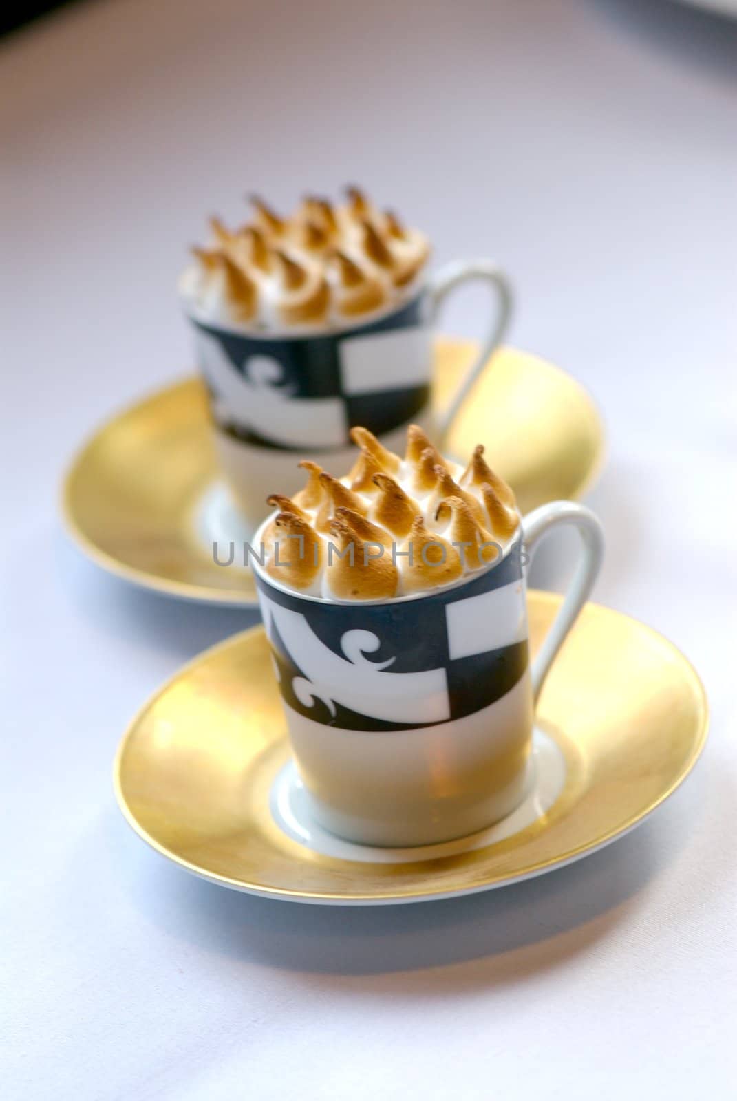 Image of mugs of cappaccino on saucers