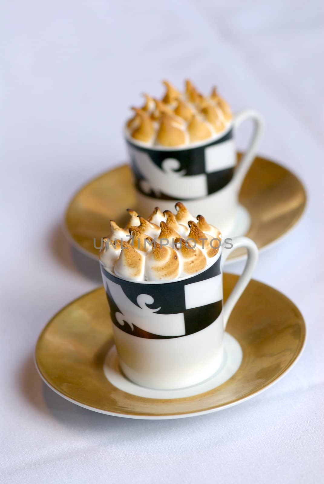 Image of mugs of cappaccino on saucers