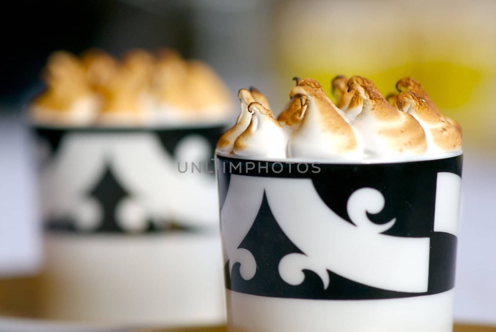 Image of mugs of cappaccino on saucers