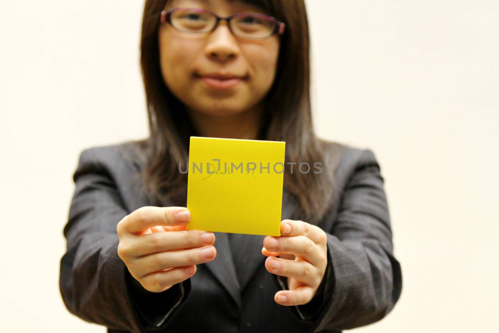 Businesswoman with deal memo paper on hands