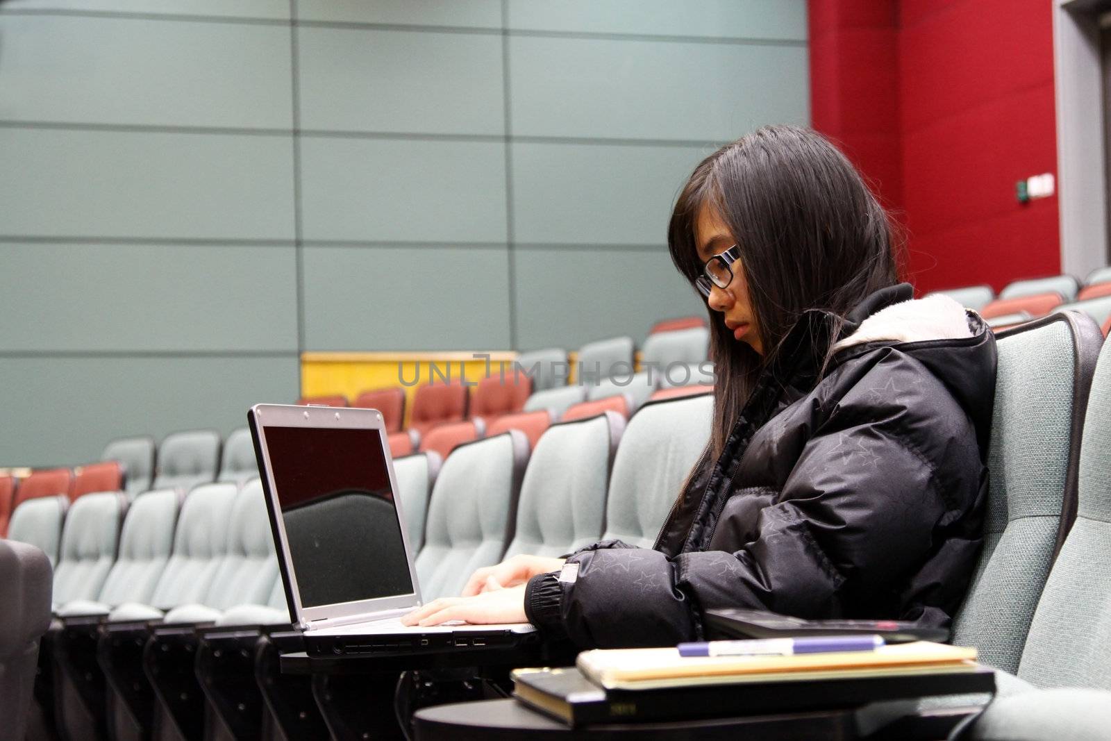 Asian student using laptop to study