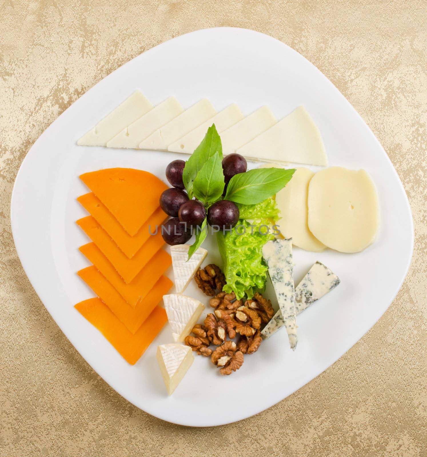 cheese with lettuce, grapes and nuts closeup