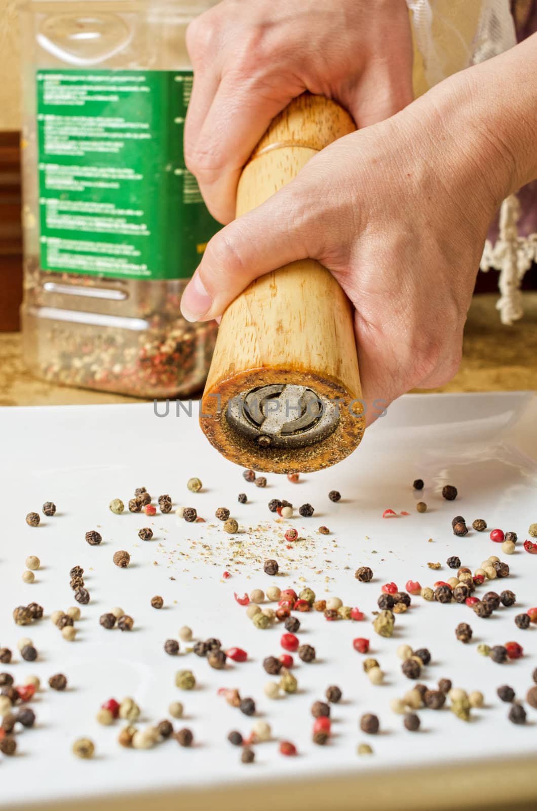 Female hands holding pepper mill