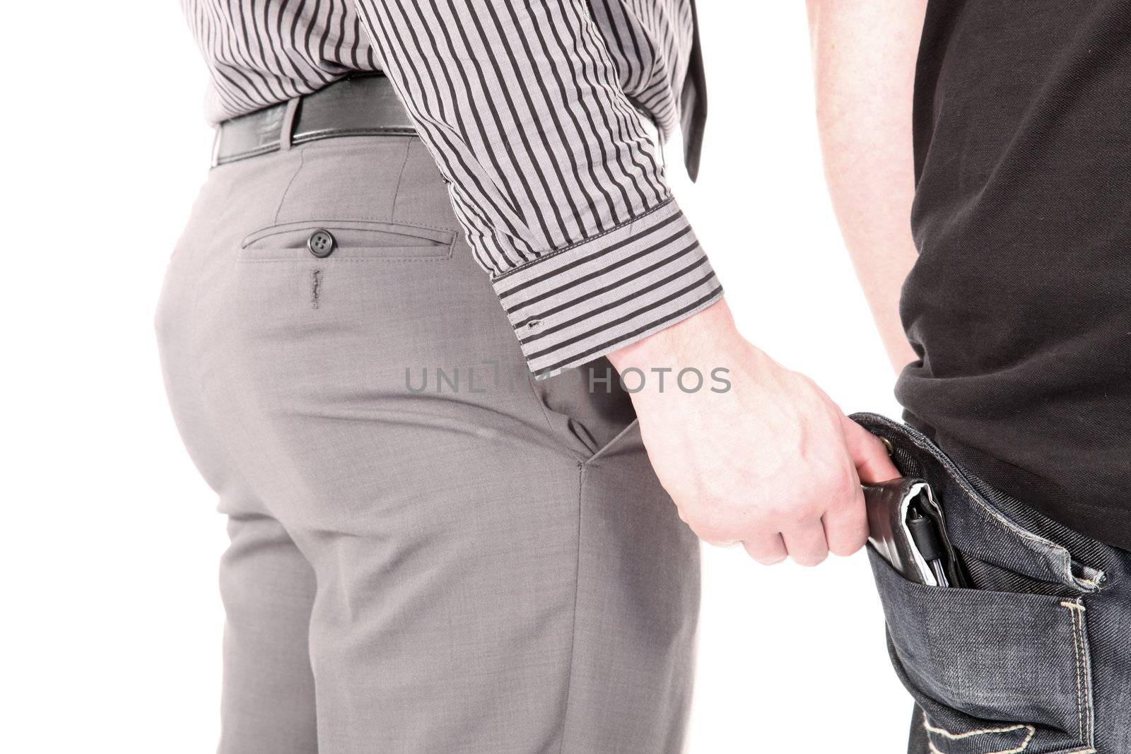 Smartly dressed male pickpocket stealing a wallet from the rear pocket of an unsuspecting victim