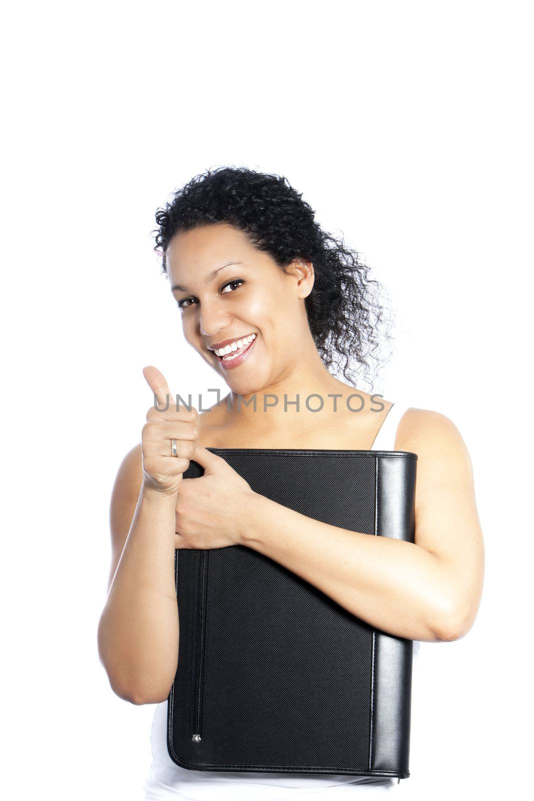 Happy attractive young African American woman with a lovely smile holding a leather folder giving a thumbs up of success and approval isolated on white