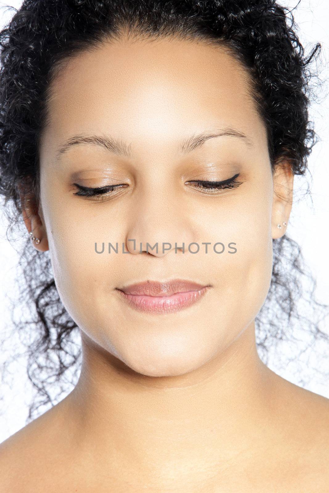 Close up portrait of smiling woman with eyes closed on white background