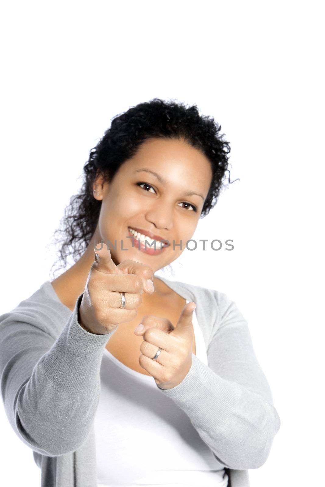 Casual smiling female pointing towards the camera isolated on white