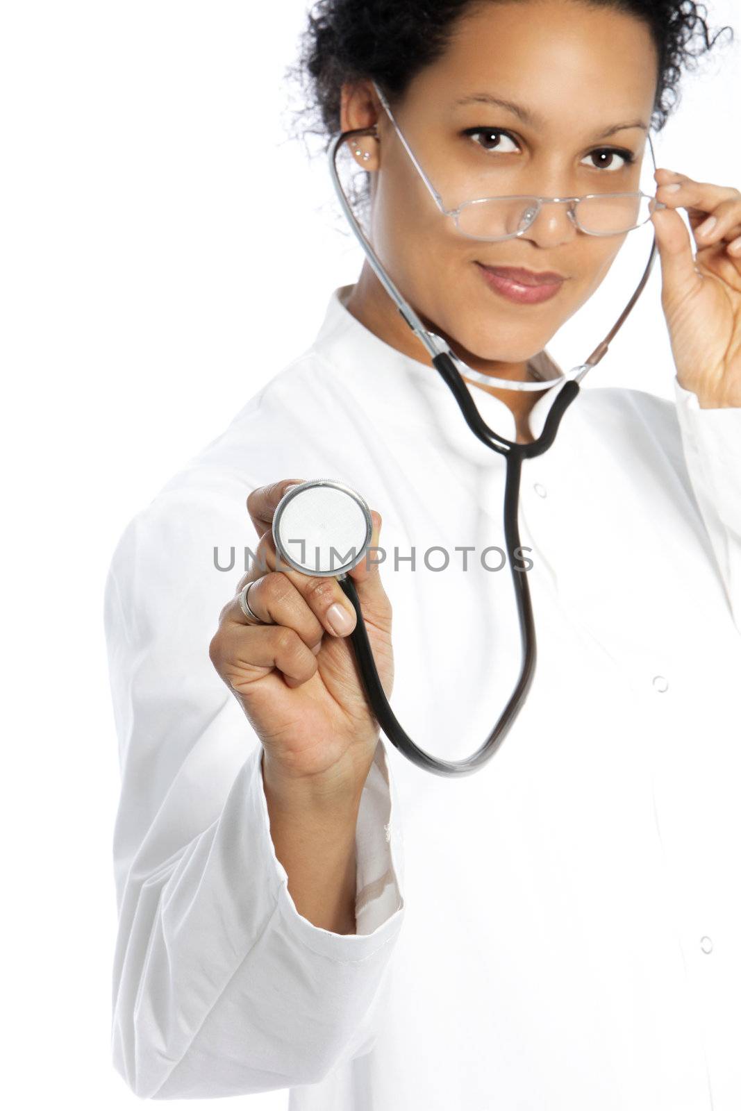 Attractive African American cardiologist or doctor wearing a stethoscope in her ears holding out the disc towards the camera as though listening