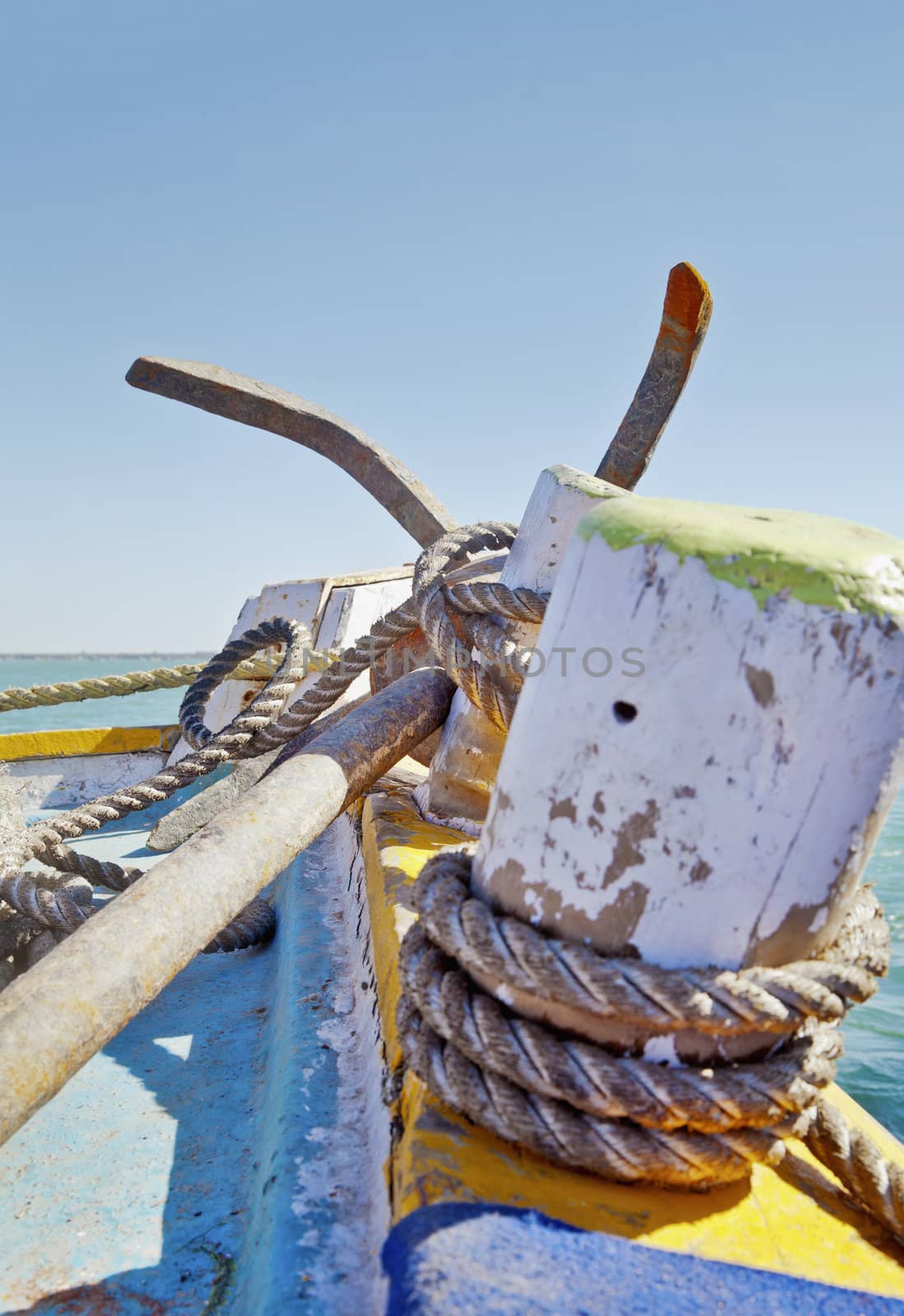 Dwarka Roadtrip. Vertical generic capture of anchor and tie ropes on a passenger ferry from Bet Dwarka to mainland India on the horizon in Gujarat