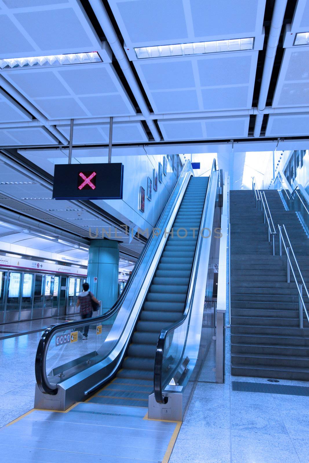 Moving escalator in train station