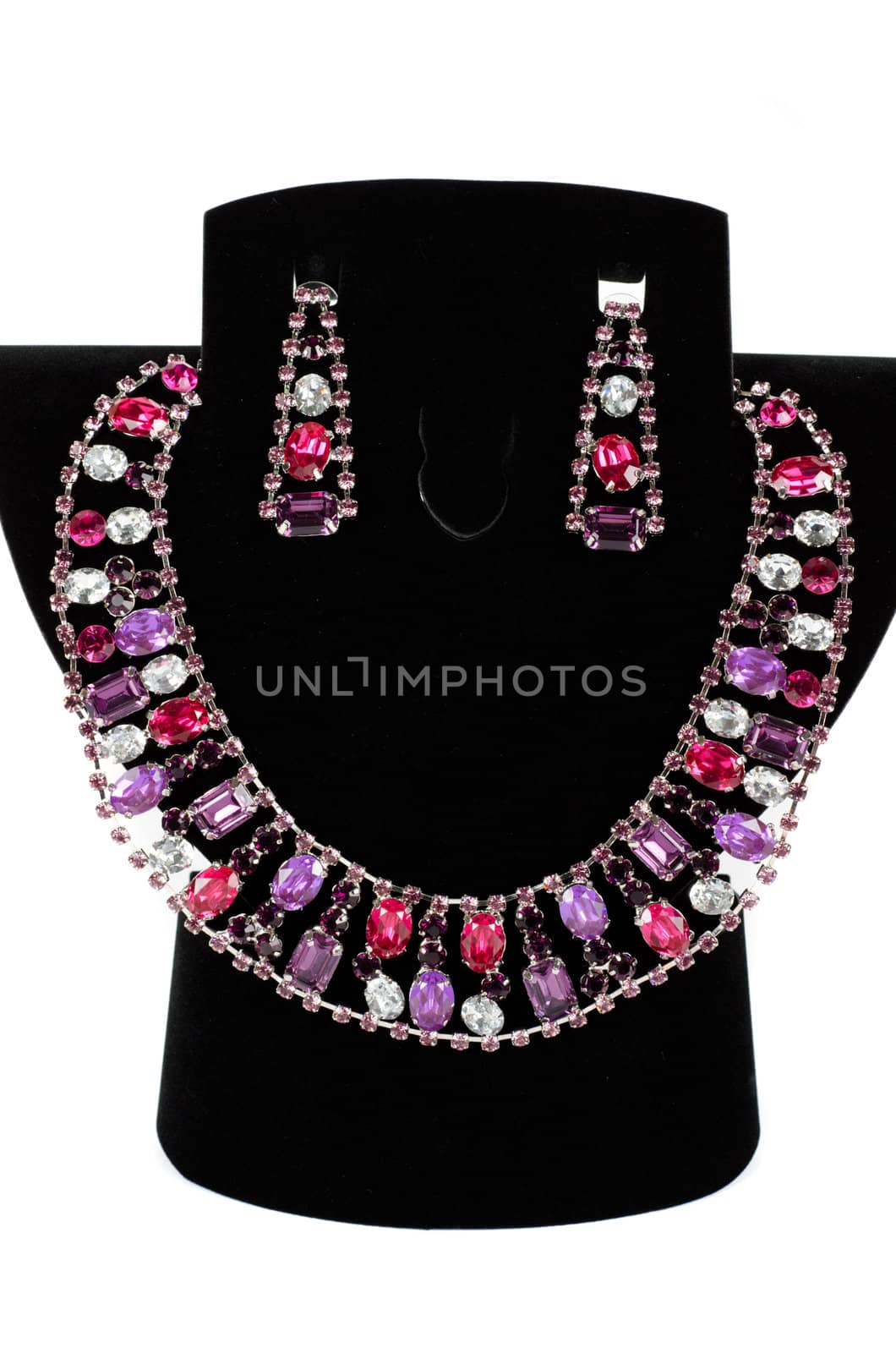 a necklace with pendants and earrings on a white background